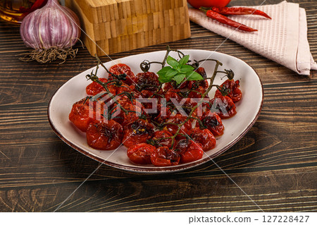 Baked cheeryy momatoes with olive oil Baked cheeryy momatoes with olive oil 127228427