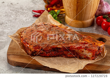 Raw marinated pork loin steak 127228728