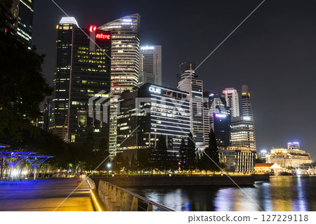 Night view of modern skyscrapers along Marina Bay in the Raffles Place financial district from the Marina Bay Sands observation deck, Singapore. Night view of modern skyscrapers along Marina Bay in the Raffles Place financial district from the Marina Bay Sands observation deck, Singapore. 127229118