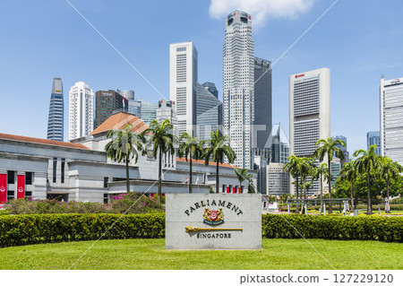 View of the Singapore Parliament House, a public building and a cultural landmark on the bank of the Singapore River, with a background of Financial District skyscrapers. View of the Singapore Parliament House, a public building and a cultural landmark on the bank of the Singapore River, with a background of Financial District skyscrapers. 127229120