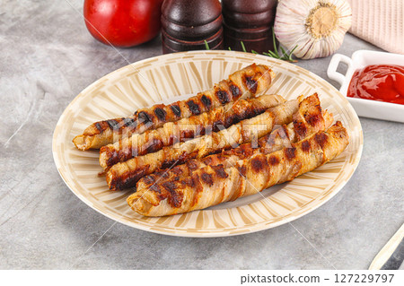 Grilled meat sausages wrapped bacon 127229797