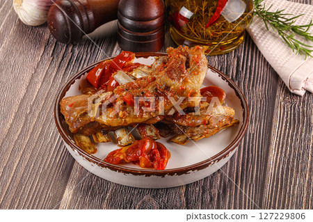 Baked lamb ribs with vegetables 127229806