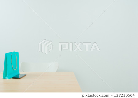 minimal interior decorate design with lshopping bag on ight brown wooden table and white chair with white isolated background minimal interior decorate design with lshopping bag on ight brown wooden table and white chair with white isolated background 127230504
