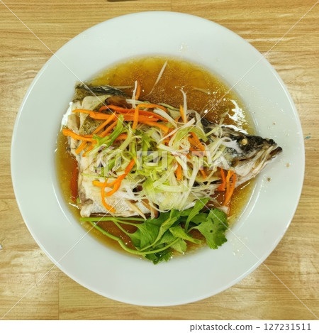 Freshly Cooked Fish Dish with Vegetables and Aromatic Broth 127231511