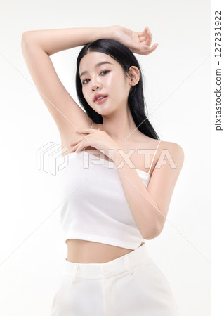 Beautiful young Asian woman lifting hand up to shows off clean and clear armpit or underarms isolated on white background, Smooth and freshness armpit concept. 127231922