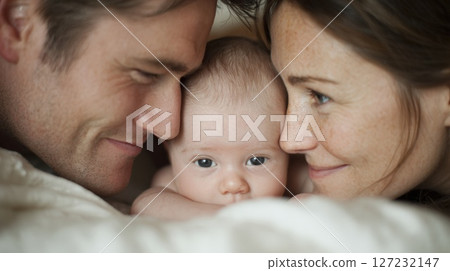 Loving Parents Admiring Their Infant Together in a Warm Family Moment 127232147