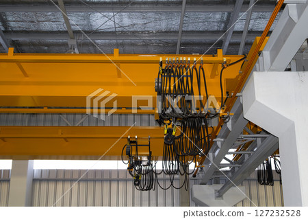 Overhead crane or lifting equipment inside factory or warehouse. 127232528