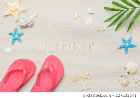 Pink flip flops, seashells, and starfishes creating relaxing summer beach background 127232571