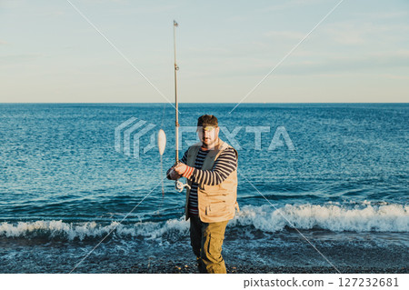 Man Fishing At The Seashore In The Morning Man Fishing At The Seashore In The Morning 127232681