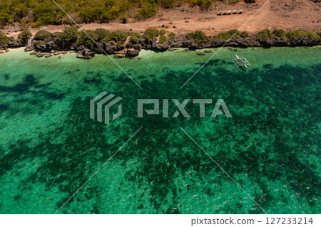 Turquoise water with coral reefs in tropical beach. Coastal cliffs in Bantayan Island. Cebu, Philippines. Turquoise water with coral reefs in tropical beach. Coastal cliffs in Bantayan Island. Cebu, Philippines. 127233214