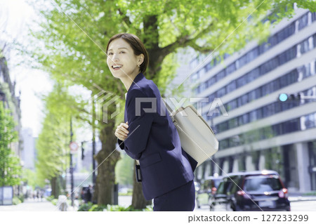 Young business woman walking in the office district 127233299