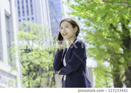 淺談智能手機在辦公區的年輕商業女人 127233481