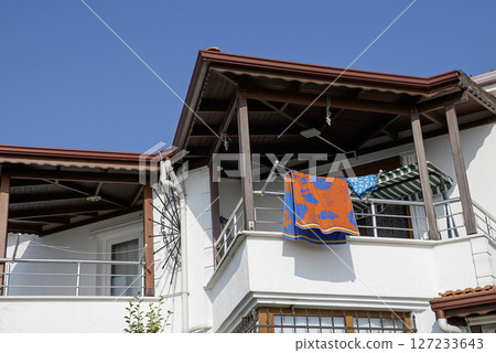 Beach towel hanging on the balcony Beach towel hanging on the balcony 127233643
