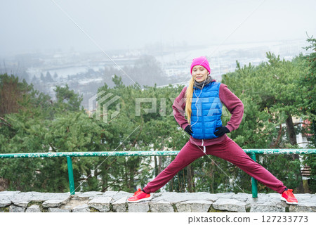 Woman wearing sportswear exercising outside during autumn Woman wearing sportswear exercising outside during autumn 127233773