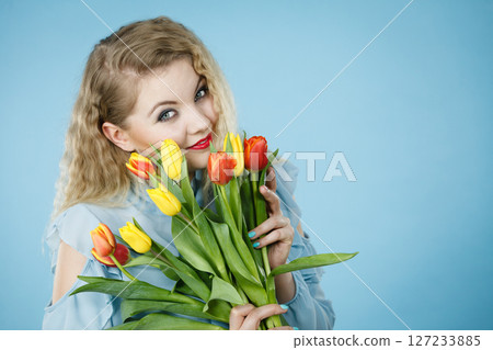 Woman holding bouquet of tulips flowers Woman holding bouquet of tulips flowers 127233885