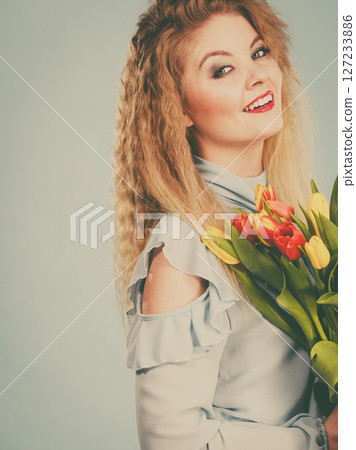 Pretty woman with red yellow tulips bunch Pretty woman with red yellow tulips bunch 127233886