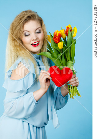 Woman holds tulips and red heart Woman holds tulips and red heart 127233887