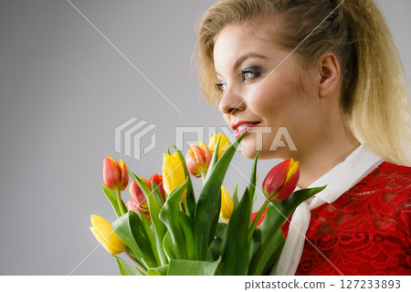 Woman holding bouquet of tulips flowers 127233893