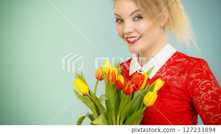 Pretty woman with red yellow tulips bunch 127233894