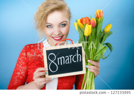 Woman holding bouquet of tulips flowers 127233895