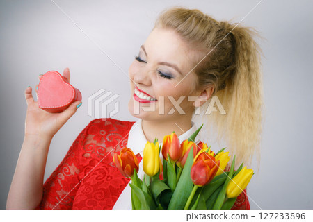 Woman holding tulips and gift 127233896
