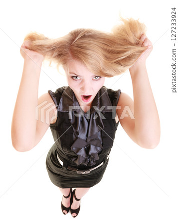 Angry furious woman screaming and pulling messy hair 127233924