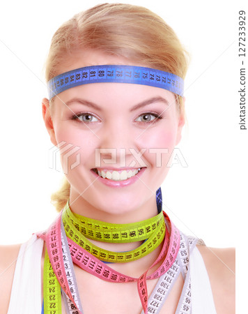 Obsessed fitness woman with a lot of colorful measure tapes 127233929