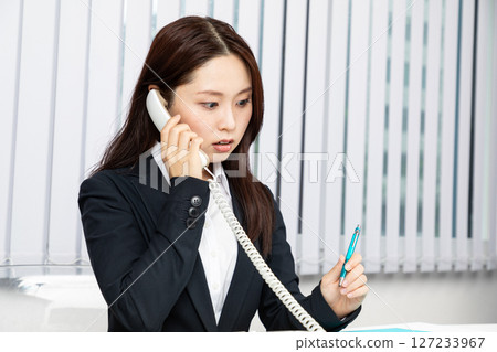 Asian woman in a suit surprised on the phone 01 Asian woman in a suit surprised on the phone 01 127233967