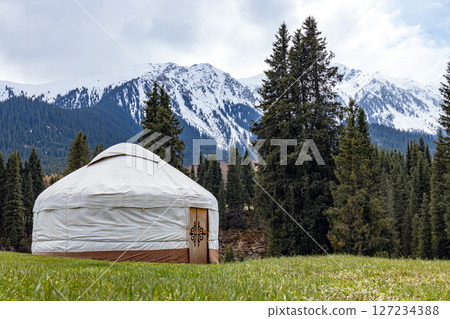 Camping in mountains, Kyrgyzstan. Traditional house of kyrgyz people, white yurt 127234388
