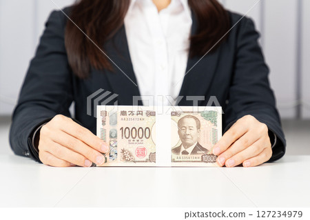 Woman in a suit holding 1 million yen 01 Woman in a suit holding 1 million yen 01 127234979