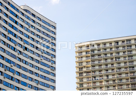 A building with many balconies is next to another building 127235597