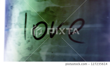 The beautiful word love is elegantly written on a colorful background 127235614