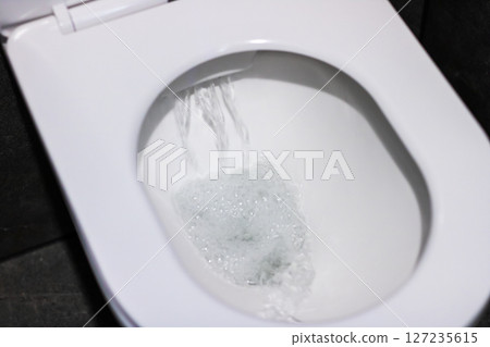 Toilet flush water flow in modern restrooms is vital for sanitation and hygiene 127235615