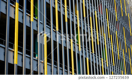 Closeup of a building with prominent yellow and blue stripes Closeup of a building with prominent yellow and blue stripes 127235639