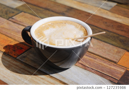 french cafe au lait in a ceramic cup on a table 127235986