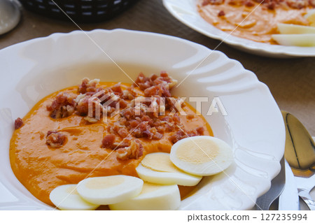 closeup of a white plate with spanish salmorejo 127235994
