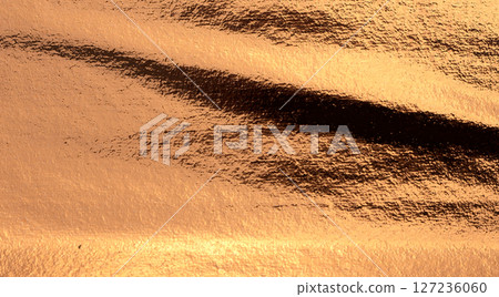 Copper metal plate with a shiny, grunge texture. Weathered, worn surface featuring a rusty, antique 127236060