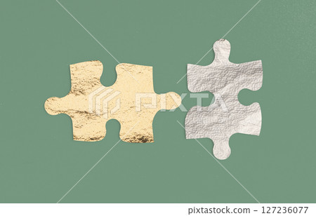 Two puzzle pieces connecting, symbolizing partnership and teamwork. A perfect fit representing Two puzzle pieces connecting, symbolizing partnership and teamwork. A perfect fit representing 127236077