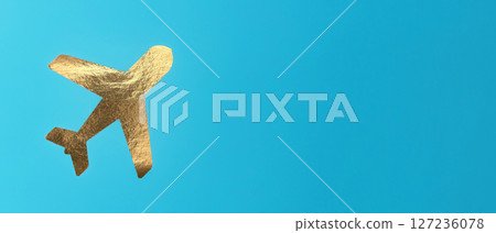 A small airplane flying in the sky, golden foil, banner . Concept of travel, aviation, and A small airplane flying in the sky, golden foil, banner . Concept of travel, aviation, and 127236078