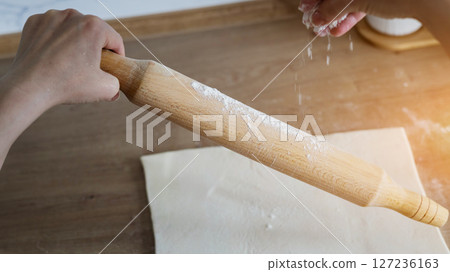 woman holding a rolling pin woman holding a rolling pin 127236163