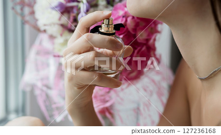 sensual woman using luxury perfume sensual woman using luxury perfume 127236168