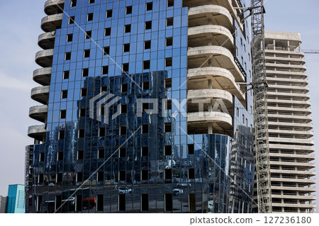 Unfinished skyscraper in city. 127236180