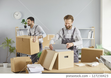 Moving delivery pack service, male movers team moving cardboard boxes, loading, unloading  127238423