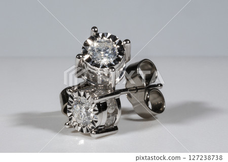 Diamond earrings. Big diamond earrings, large solitaire earrings on white background. Diamond earrings. Big diamond earrings, large solitaire earrings on white background. 127238738