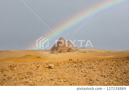 Egypt. Cairo - Giza. Rainbow over the pyramids. General view of pyramids from the Giza Plateau (three pyramids known as Queens' Pyramids on front side; next in order from left: the Pyramid of Menkaure Egypt. Cairo - Giza. Rainbow over the pyramids. General view of pyramids from the Giza Plateau (three pyramids known as Queens' Pyramids on front side; next in order from left: the Pyramid of Menkaure 127238869