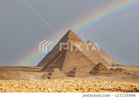Egypt. Cairo - Giza. Rainbow over the pyramids. General view of pyramids from the Giza Plateau (three pyramids known as Queens' Pyramids on front side; next in order from left: the Pyramid of Menkaure Egypt. Cairo - Giza. Rainbow over the pyramids. General view of pyramids from the Giza Plateau (three pyramids known as Queens' Pyramids on front side; next in order from left: the Pyramid of Menkaure 127238946