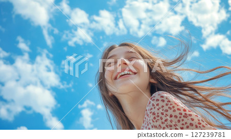 Joyful Woman Smiling Under Blue Sky 127239781