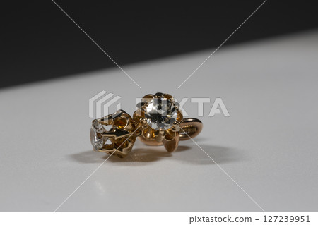 Diamond Earrings Isolated on White Background. Yellow Gold Diamond Earring Pair with 750 Stamp Denoting 18-Carat Yellow Gold. Diamond Earrings Isolated on White Background. Yellow Gold Diamond Earring Pair with 750 Stamp Denoting 18-Carat Yellow Gold. 127239951