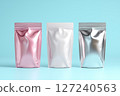 3D rendering of three pink, white, and rose gold mylar stand-up pouches with no graphics or text on a light blue background 127240563