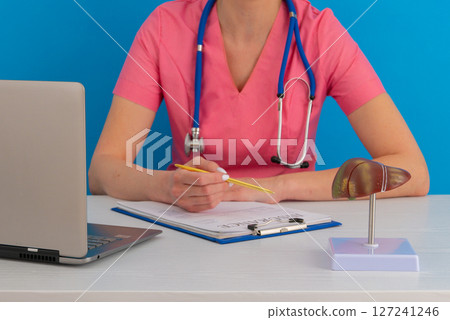 Doctor work in office with anatomical model of human liver on desk. Concept of healthy liver and donation. 127241246